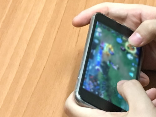 Person playing a game on their smart phone